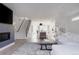 Spacious living room featuring a fireplace, staircase, and an open floor plan leading to the kitchen at 1322 Raleigh St, Denver, CO 80204