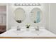 Bright bathroom featuring double sinks, white cabinets, and modern lighting fixtures at 3715 Wolff St, Denver, CO 80212