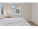 Serene bedroom featuring a cozy bed, plush carpet, and a bright window at 3715 Wolff St, Denver, CO 80212