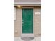 A close-up of the home's green front door with modern hardware and the house number displayed at 3715 Wolff St, Denver, CO 80212