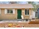 Charming brick home featuring a well-maintained front yard with planters and a cozy seating area near the entrance at 3715 Wolff St, Denver, CO 80212