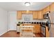 Bright kitchen with stainless steel appliances, wooden cabinets, a black tile backsplash, and an island at 3715 Wolff St, Denver, CO 80212