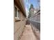 A narrow side yard with a brick wall, fenced in, offering a private outdoor space at 3715 Wolff St, Denver, CO 80212
