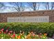 Stone sign for Cherry Hills Country Club surrounded by colorful tulips and lush greenery at 4480 S Franklin St, Cherry Hills Village, CO 80113