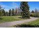 Exterior view of a home, showcasing the winding driveway and mature trees on the property at 4480 S Franklin St, Cherry Hills Village, CO 80113