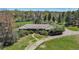 This home boasts a unique roof style and is framed by lush greenery and open spaces at 4480 S Franklin St, Cherry Hills Village, CO 80113