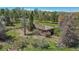 An exterior view of a single story home with mature trees, and an overgrown front landscape at 4480 S Franklin St, Cherry Hills Village, CO 80113