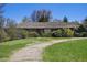 Charming single-story brick home with a unique roof, mature shrubs and large lawn area at 4480 S Franklin St, Cherry Hills Village, CO 80113