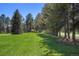 Open lawn area surrounded by a variety of trees, offering a park-like setting at 4480 S Franklin St, Cherry Hills Village, CO 80113