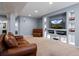 This basement features recessed lights, built-in shelves with decor, and a leather couch at 3917 Starry Night Loop, Castle Rock, CO 80109