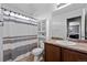 This is a full bathroom with a shower-tub combo, white cabinet over the toilet, and vanity sink at 3917 Starry Night Loop, Castle Rock, CO 80109