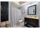 Bathroom featuring a shower-tub combo with a chevron shower curtain and black vanity at 3917 Starry Night Loop, Castle Rock, CO 80109
