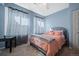 Airy bedroom features a bed with gray tufted headboard, neutral walls, and a window at 3917 Starry Night Loop, Castle Rock, CO 80109