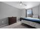 This bedroom is carpeted and has a single bed with a ceiling fan and dresser at 3917 Starry Night Loop, Castle Rock, CO 80109