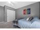 This is a cozy carpeted bedroom with a ceiling fan, closet and a sport-themed painting at 3917 Starry Night Loop, Castle Rock, CO 80109