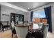 Bright dining room with a large round table, chairs, and a view of the backyard at 3917 Starry Night Loop, Castle Rock, CO 80109