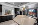 Modern kitchen featuring dark cabinets, stainless steel appliances, and a large center island with pendant lighting at 3917 Starry Night Loop, Castle Rock, CO 80109