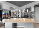 Open kitchen features bar stool seating and pendant lights, connecting to the living room and dining area at 3917 Starry Night Loop, Castle Rock, CO 80109