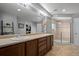 This bathroom features a double vanity, spacious walk-in shower, and tiled floors at 3917 Starry Night Loop, Castle Rock, CO 80109