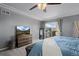 This main bedroom features a ceiling fan, TV atop a dresser, and a sliding glass door to a patio at 3917 Starry Night Loop, Castle Rock, CO 80109