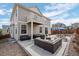 Backyard patio features a seating area, hot tub, and an upper-level balcony at 3917 Starry Night Loop, Castle Rock, CO 80109