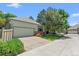 Charming home featuring a two-car garage, lush lawn, and mature trees, perfect for suburban living at 6900 W Grant Ranch Blvd # 59, Littleton, CO 80123
