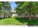 Lovely home with large windows, inviting front porch, and a meticulously maintained lawn at 6900 W Grant Ranch Blvd # 59, Littleton, CO 80123
