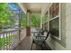 Relaxing front porch with seating area, featuring views of the tree-lined street and neighborhood at 6900 W Grant Ranch Blvd # 59, Littleton, CO 80123