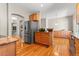 Open concept kitchen with stainless steel refrigerator and beautiful wooden cabinetry at 6900 W Grant Ranch Blvd # 59, Littleton, CO 80123