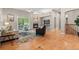 Cozy living room with a fireplace, hardwood floors, and access to the porch at 6900 W Grant Ranch Blvd # 59, Littleton, CO 80123