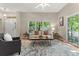 Spacious living room with large windows, neutral décor, hardwood floors, and access to a porch at 6900 W Grant Ranch Blvd # 59, Littleton, CO 80123