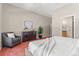 Comfortable main bedroom featuring a gray chair, dresser, and ensuite bathroom access at 6900 W Grant Ranch Blvd # 59, Littleton, CO 80123