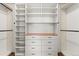 Spacious walk-in closet with custom shelving and drawer units for optimal organization at 6900 W Grant Ranch Blvd # 59, Littleton, CO 80123