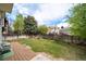 The backyard showcases a lush lawn, established garden beds, a wood deck, and a full perimeter fence at 7072 Palisade Dr, Highlands Ranch, CO 80130