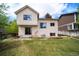 The backyard features a lush lawn, a wood deck, a sliding glass door, and partial fencing around the perimeter at 7072 Palisade Dr, Highlands Ranch, CO 80130