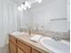 Bright bathroom featuring double sinks, a large mirror, and light fixtures for a functional space at 7072 Palisade Dr, Highlands Ranch, CO 80130