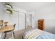 Cozy bedroom featuring a built in desk and a sliding door closet, providing ample storage and organization at 7072 Palisade Dr, Highlands Ranch, CO 80130
