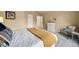 Comfortable bedroom featuring a bed, chair and a view into the hall of a neutral colored room at 7072 Palisade Dr, Highlands Ranch, CO 80130