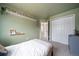 Serene bedroom with soft green walls, offering a calming and inviting atmosphere for a peaceful retreat at 7072 Palisade Dr, Highlands Ranch, CO 80130