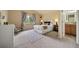 Cozy bedroom showcasing a large window, comfortable bed, and neutral decor, leading to the bathroom at 7072 Palisade Dr, Highlands Ranch, CO 80130