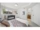 Bright bedroom features a window, keyboard, and decor adjacent to a bathroom and a gray and white color palette at 7072 Palisade Dr, Highlands Ranch, CO 80130
