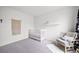 Bright Bedroom with a crib, chair, and macrame decor, creating a serene and cozy atmosphere for a  at 7072 Palisade Dr, Highlands Ranch, CO 80130