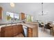 Bright kitchen featuring wood cabinets, granite countertops, stainless steel appliances, and open dining area at 7072 Palisade Dr, Highlands Ranch, CO 80130