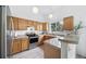 Well-lit kitchen featuring wooden cabinets, granite countertops, stainless steel appliances, and a breakfast bar at 7072 Palisade Dr, Highlands Ranch, CO 80130