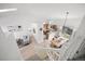 Bright, open-concept living space with hardwood floors, modern furniture, and a kitchen view from the stairs at 7072 Palisade Dr, Highlands Ranch, CO 80130