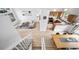 Bright open-concept living space featuring hardwood floors, modern furniture, and a kitchen at 7072 Palisade Dr, Highlands Ranch, CO 80130