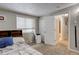 This bedroom features a window unit AC and an open doorway to an adjoining bathroom at 841 Crisman Dr # 9, Longmont, CO 80501