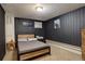 Cozy bedroom features dark walls, soft carpeting and a comfortable-looking bed at 841 Crisman Dr # 9, Longmont, CO 80501