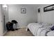 Simple bedroom with a bed, laundry basket, neutral walls and carpeted floor at 841 Crisman Dr # 9, Longmont, CO 80501