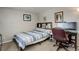 Small bedroom featuring a bed, desk and chair with neutral walls and carpeting at 841 Crisman Dr # 9, Longmont, CO 80501
